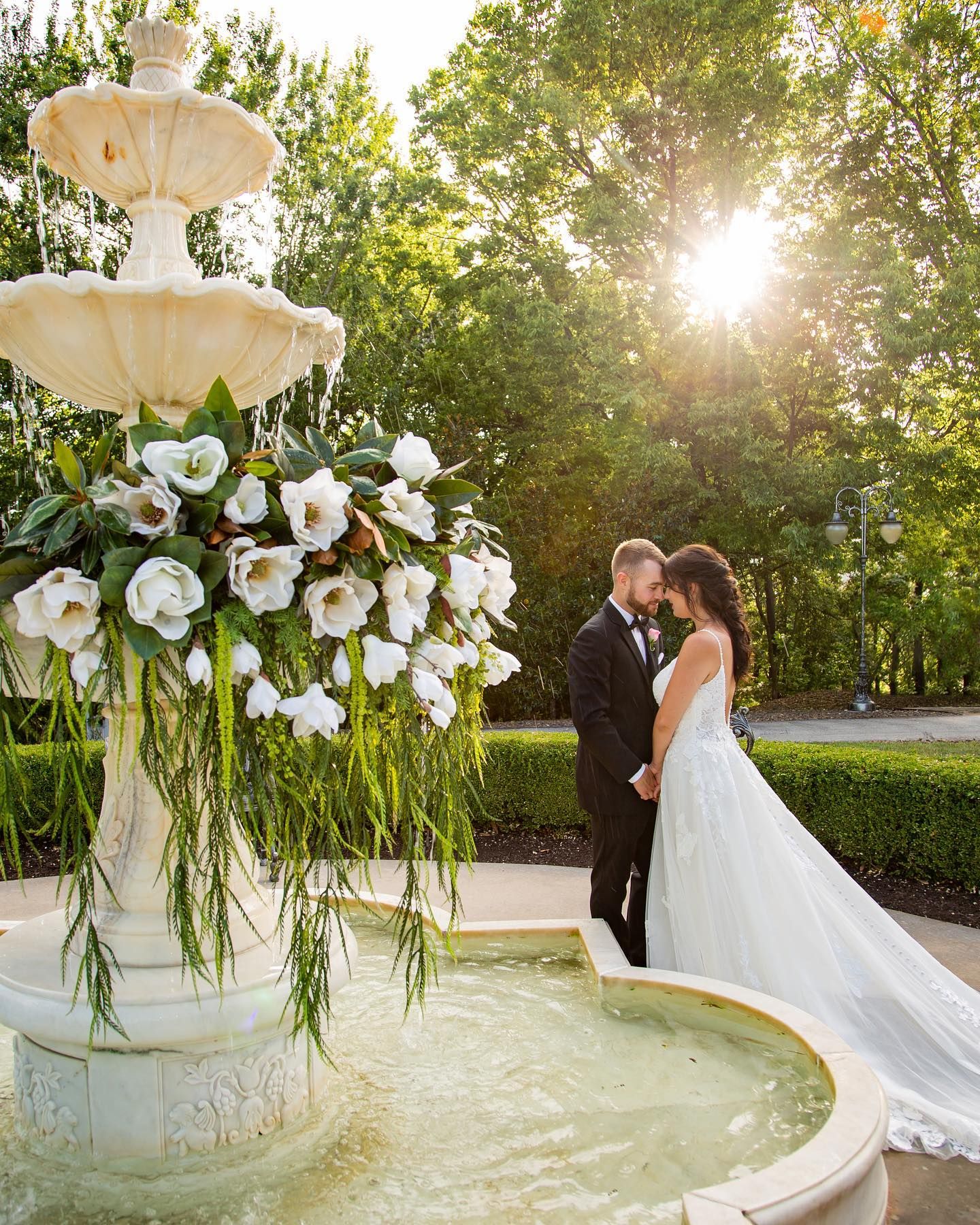 A couple embracing beside the fountain at Lovell Estate